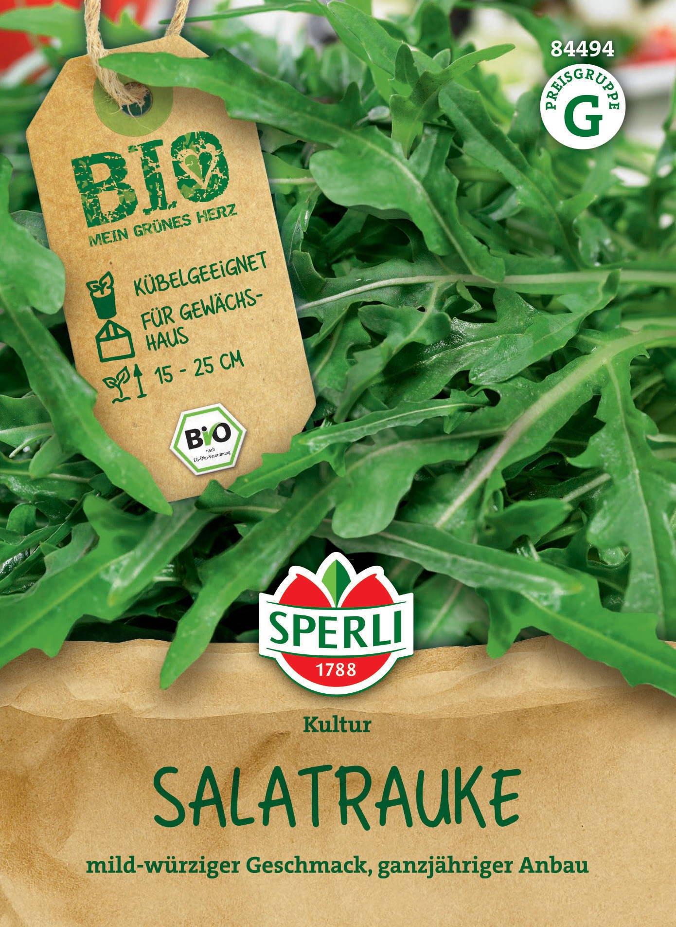 Grünes Salatblatt, auf brauner Verpackung mit Sperli-Logo, grüner Kreis mit G, gelber Tag mit Bio- und Wachstumsangaben.