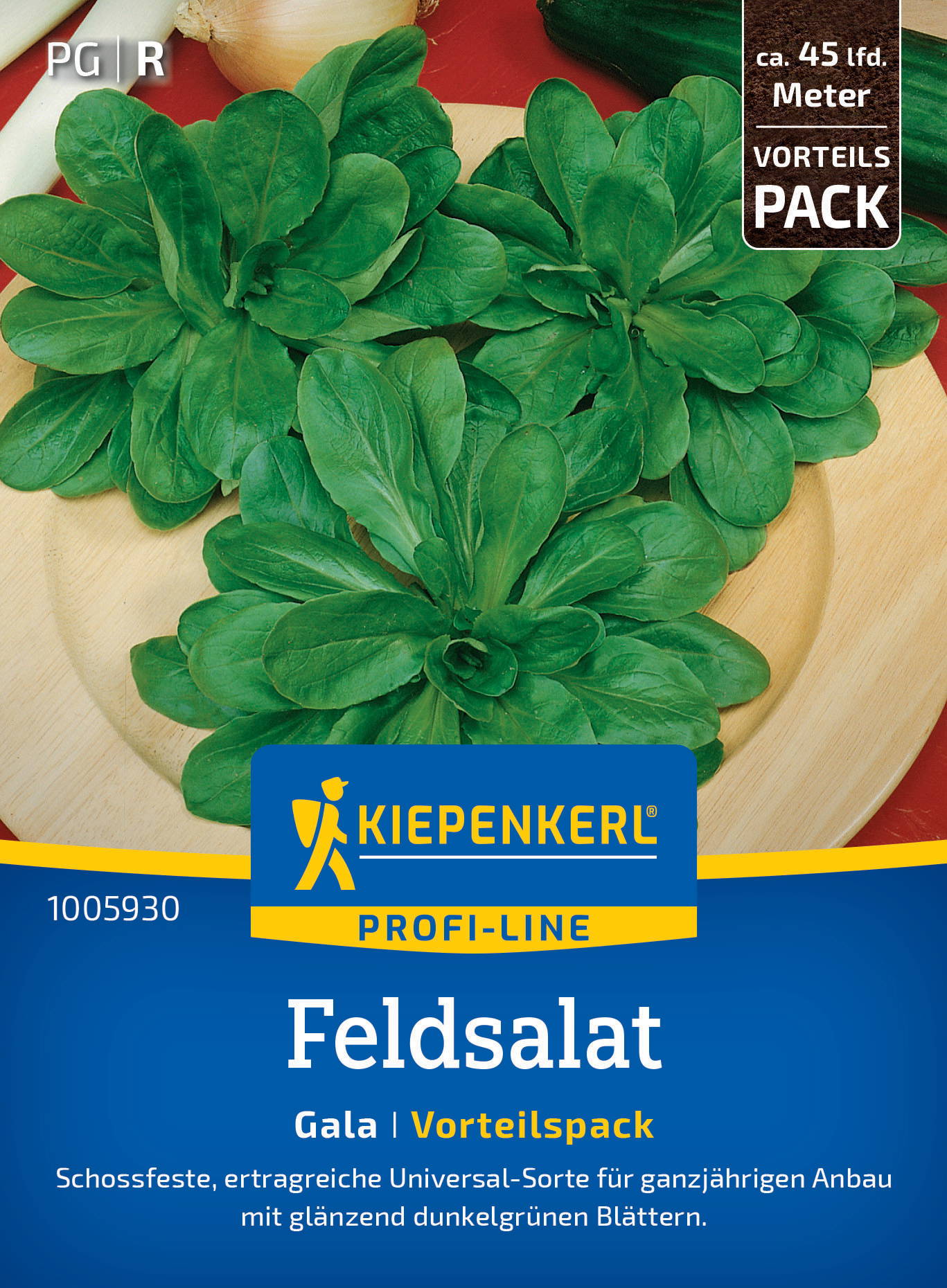 Drei kleine Felssalatpflanzen mit glänzenden dunklen Blättern auf einer Holzplatte, Packungsbeschreibung auf der Verpackung.